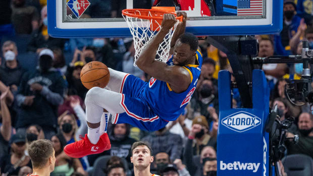 November 8, 2021; San Francisco, California, USA; Golden State Warriors forward Draymond Green (23) dunks the basketball against Atlanta Hawks guard Bogdan Bogdanovic (13) and forward Danilo Gallinari (8) during the second quarter at Chase Center.